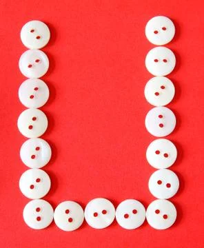 Letter "u" from buttons on a red background Stock Illustration