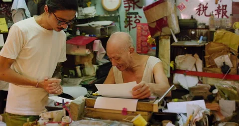 A letter writer artisan serving customer, He produces tax forms, accounting, let Stock Footage 201095373