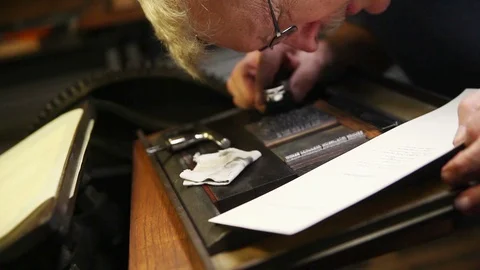 Letterpress printer checks for errors in his type Stock Footage 95197911