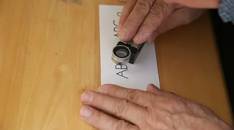 Letterpress printer checks work with magnifier Stock Footage 12169793