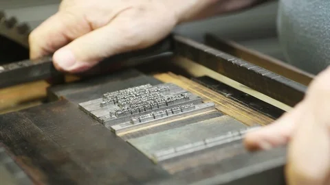 Letterpress printer puts metal type block in chase Stock Footage 95197725
