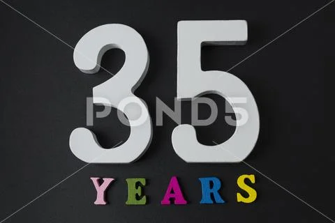 Letters and numbers thirty-five on the black background. Stock Photos