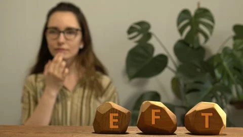 Letters EFT and woman tapping meridian point in blurred background. Stock Footage 277458173