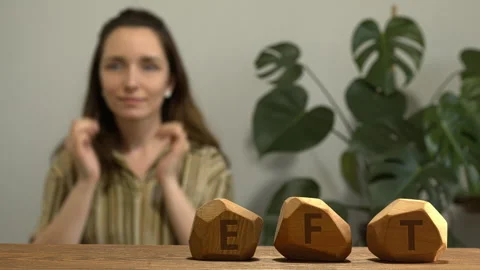 Letters EFT and woman tapping SE meridian point in blurred background. Stock Footage 277992583