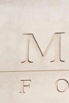 Letters engraved in stone Stock Photos