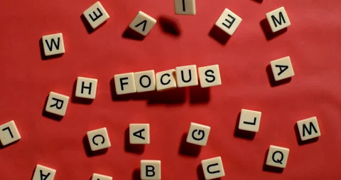 Letters fall into place to spell Focus on Red background 스톡 동영상 254037820