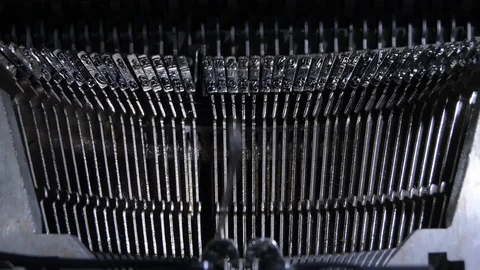 Letters hitting the paper while typing in an old qwerty typewriter Stockbeeldmateriaal 115361200