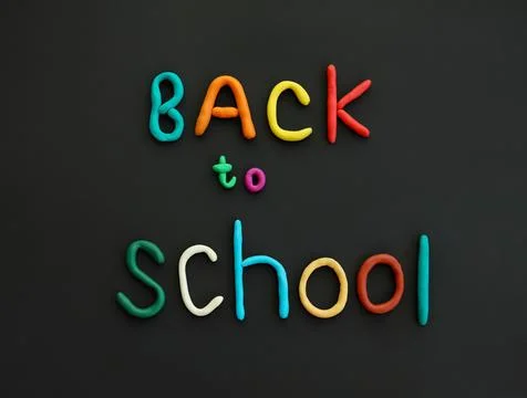 Letters made of multi-colored plasticine back to school on black background Stock Photos