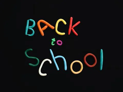 Letters made of multi-colored plasticine back to school in wry funny style on Stock Photos