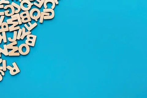Letters scattered on blue background with space for text Stock Photos