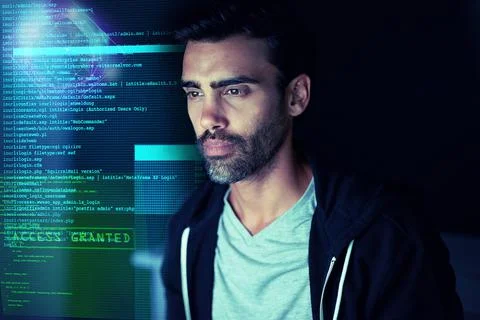 Letting himself get lost in the code. Shot of a focussed computer hacker usin Stockfoto's