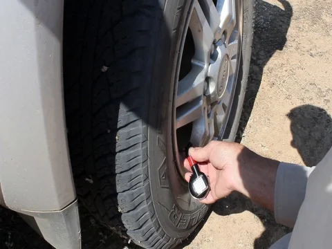 LETTING TYRES DOWN Stock Footage 100413996