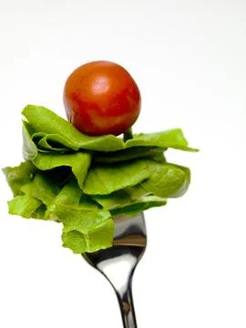 Lettuce and tomato on the fork Stock Photos