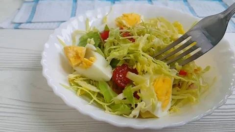 Lettuce, egg, cabbage, tomato, fork Stock Footage 89765732