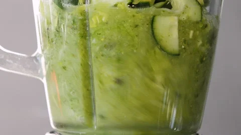 Lettuce, green spinach, celery and cucumber are stirred in a mixer to make a Stock Footage 178485047