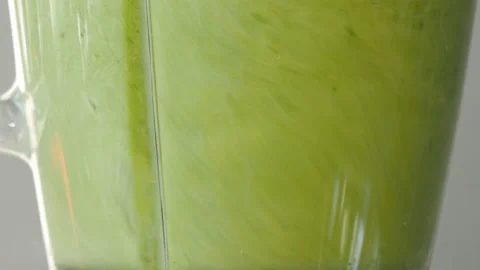 Lettuce, green spinach, celery and cucumber are stirred in a mixer to make a Stock Footage 178485243