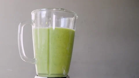 Lettuce, green spinach, celery and cucumber are stirred in a mixer to make a Stock Footage 178485293
