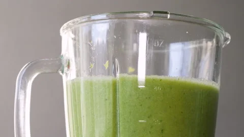 Lettuce, green spinach, celery and cucumber are stirred in a mixer to make a Stock Footage 178485504