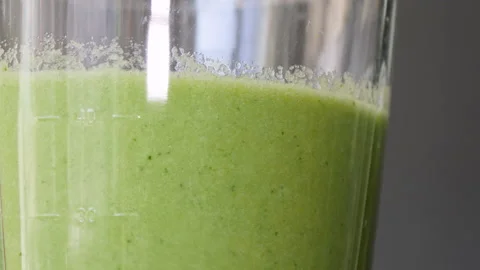 Lettuce, green spinach, celery and cucumber are stirred in a mixer to make a Stock Footage 178485554