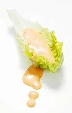 A lettuce leaf with dressing Stock Photos