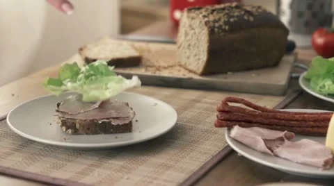 Lettuce leaf falling on slice of bread, slow motion shot at 240fps HD 動画素材 12364004