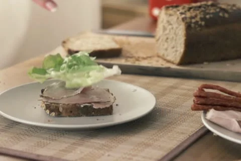 Lettuce leaf falling on slice of bread, slow motion shot at 240fps NTSC 動画素材 12364008