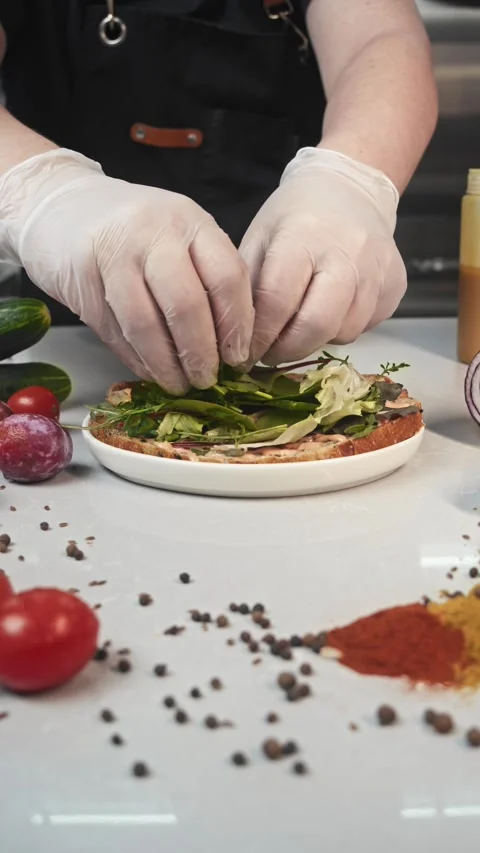 Lettuce leaves are added to the composition of a juicy sandwich, creating a Stock Footage 292155533