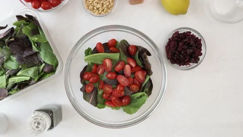 Lettuce salad with cherry tomatoes, dry cranberries and pine nuts Stock Footage 138531920