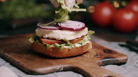LEtucce Being Placed On Sourdough Bun With Hallomie, Lettuce and Tomato Video stock 134403363