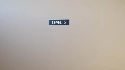 Level 5 sign on beige wall in a modern building interior Stock Footage 276341711