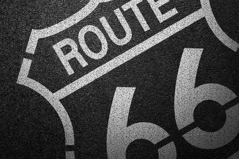 Level asphalted road with a dividing stripes. The texture of the tarmac. Stock Photos