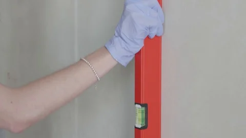 Level checks the walls after plastering Stock Footage 130049980