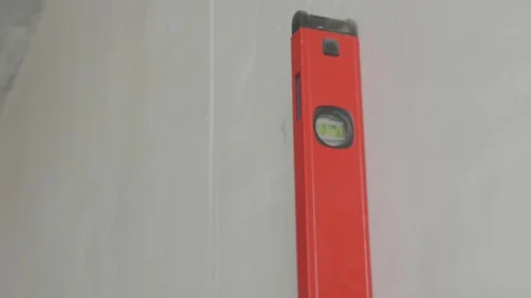 Level checks the walls after plastering Stock Footage 130049995