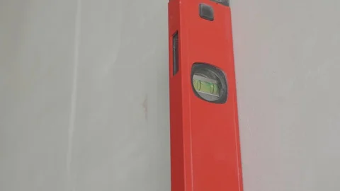 Level checks the walls after plastering Stock Footage 130050003