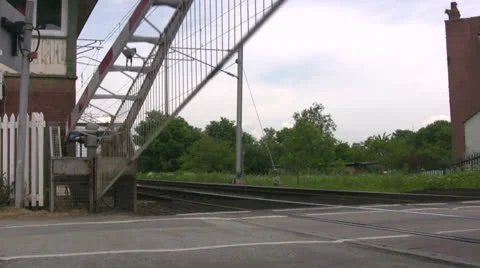 Level crossing barrier coming down Stock Footage 23936890