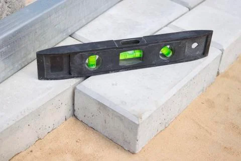 Level gauge it is applied at stone blocks laying Stock Photos