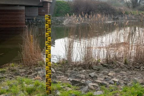 A level indicator next to a river Stock Photos