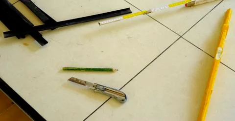 Level, utility knife, strips, eec. tools work for a floating floor on steel f Stock Photos