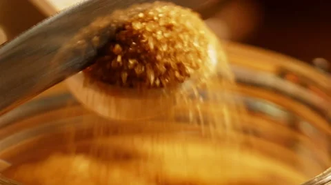 Leveling brown sugar in measuring scoop Stock Footage 49737442