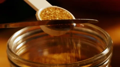 Leveling brown sugar in measuring scoop Stock Footage 49738669
