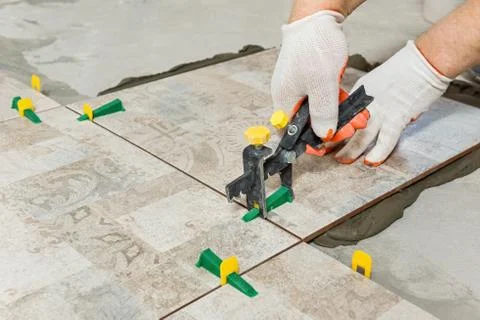 Leveling the ceramic tile. Stock Photos