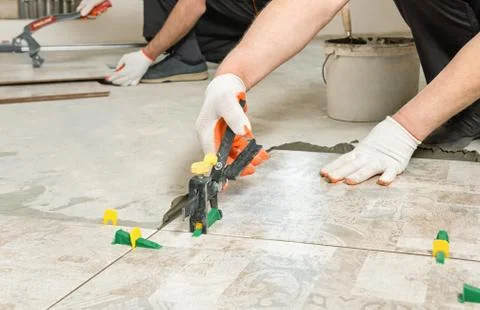Leveling the ceramic tile. Stock Photos