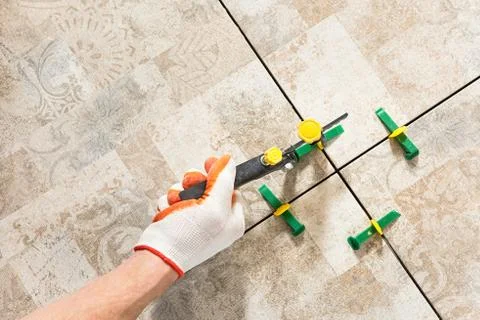 Leveling the ceramic tile. Stock Photos