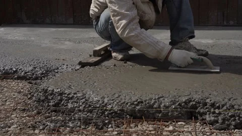 Leveling the concrete mixture of the foundation Stock Footage 307385372