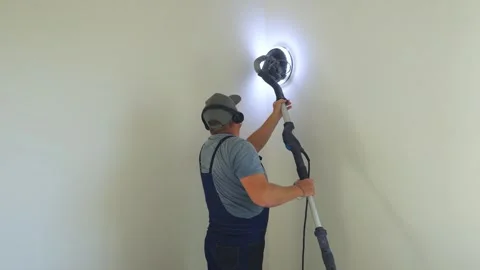 Leveling corner walls after puttying with sander, vacuum cleaner. Final sanding Stock-Footage 319210715