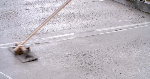 Leveling fresh poured concrete at construction site close up, 4K Stock Footage 110243342