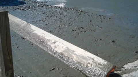 Leveling freshly poured concrete on the path, sunny day Stock Footage 311796228