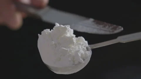 Leveling a measuring spoon Stock Footage 64013346