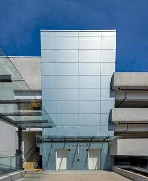 Levels of a parkade with two elevators on blue sky background Stock Photos