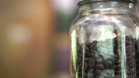 Levels of roasted coffee beans in glass jar, light, medium and dark roast Stock Footage 72367880